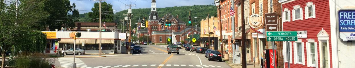 Landscape photo showing downtown Thomaston, CT with various street signs