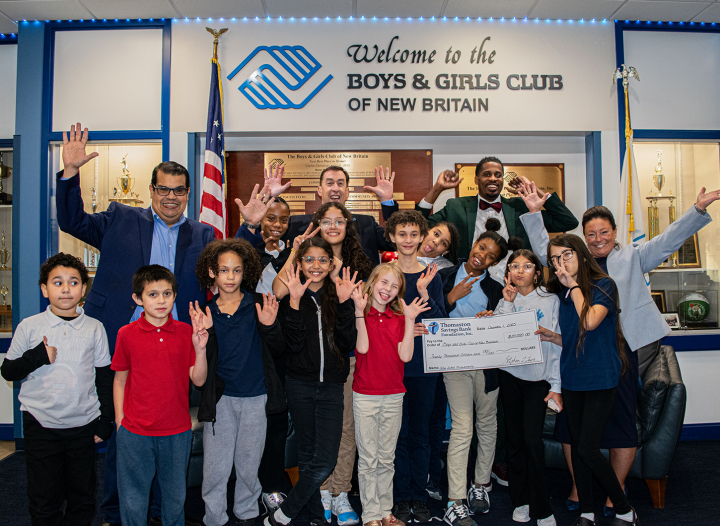 Thomaston Savings Bank President and CEO Stephen Lewis standing with recipients at Boys and Girls Club of New Britain event, with large check in hand