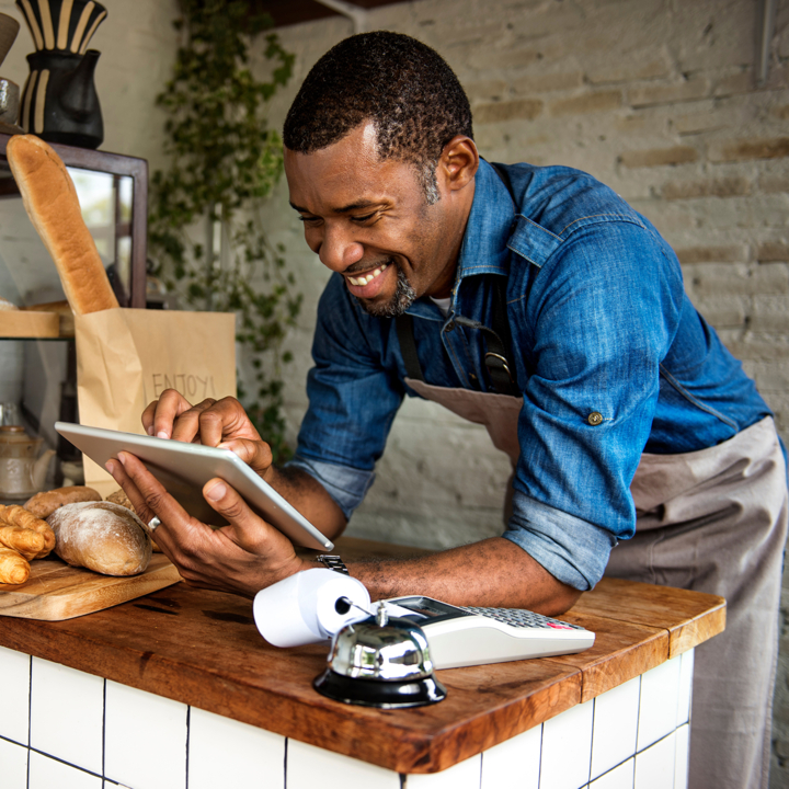 Male business owner using a tablet device in his bakery
