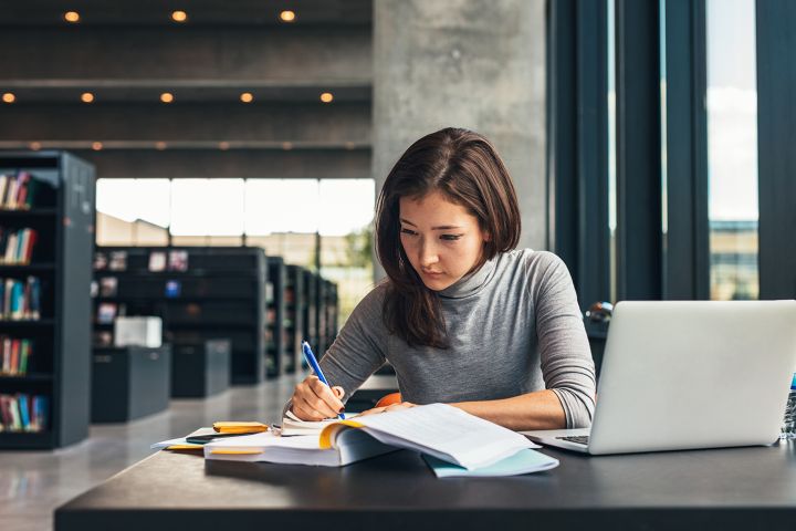 college student in library studying